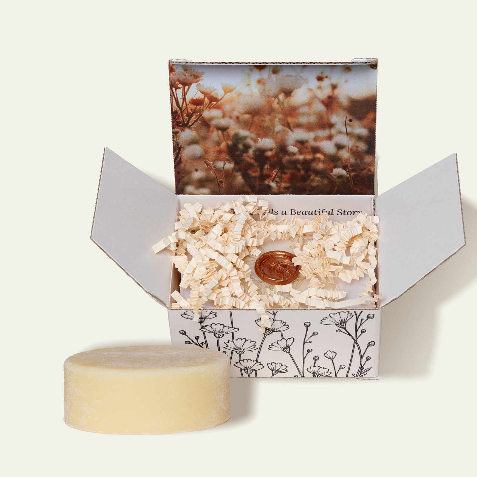 M. Carya Body Butter Bar partially unboxed with floral-print interior and visible 3.5 oz bar